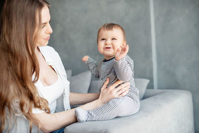 Happy mother with baby at home