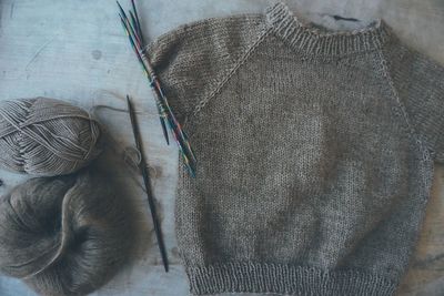 High angel view of knitting work on wooden table 