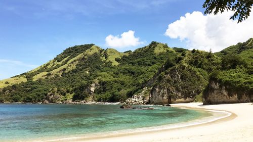 Scenic view of sea and mountains against sky