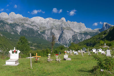Scenic view of field and mountains against sky