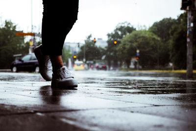 Low section of woman walking in rain