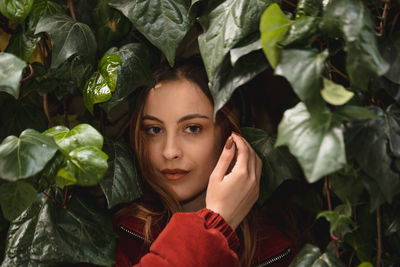 Portrait of woman amidst plant