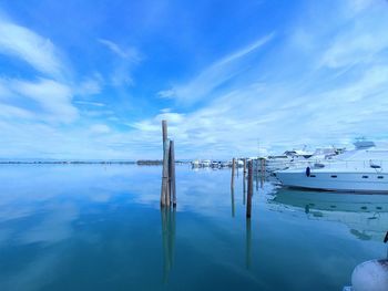 View of jetty in sea against cloudy sky