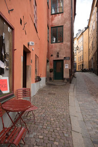 Empty chairs against buildings