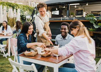 Portrait of smiling friends working at table