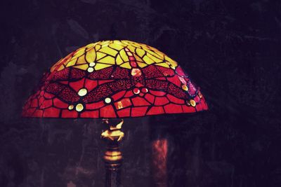 Close-up of illuminated lighting equipment hanging at night