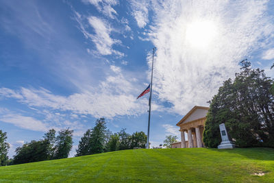 Scenic view of field and buildings against sky