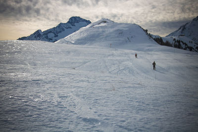 People skiing on snowcapped mountain