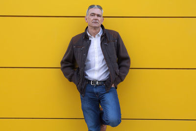Portrait of man on yellow wall