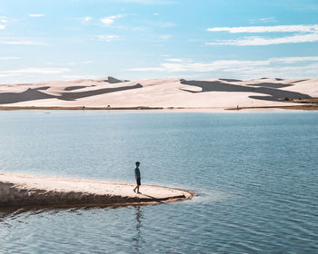 High angle view of man walking on beach against sky