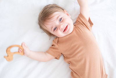 High angle view of baby girl lying on bed