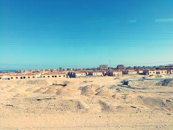 Scenic view of desert against clear blue sky