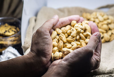 Cashew nuts in hand. healthy fats and protein food agriculture industry.