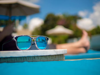 Close-up of sunglasses on swimming pool