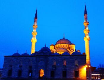 Low angle view of mosque against blue sky