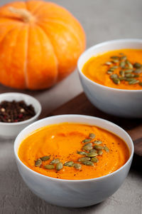 Close-up of pumpkin soup in bowl on table