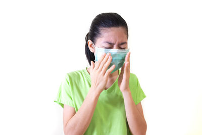 Portrait of a young woman over white background