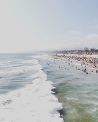 People at beach against clear sky