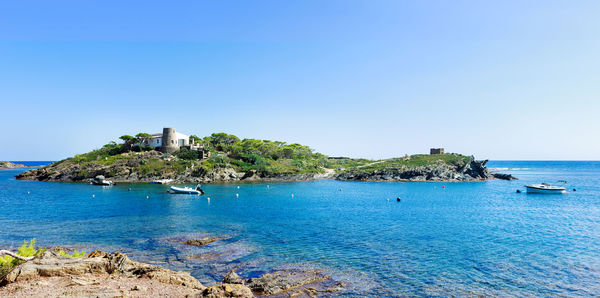 Scenic view of sea against clear blue sky