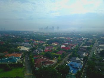 High angle view of buildings in city against sky