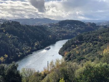 High angle view of river amidst trees against sky