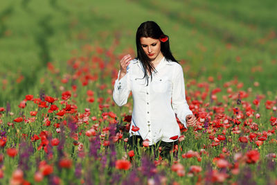 Young woman standing on field