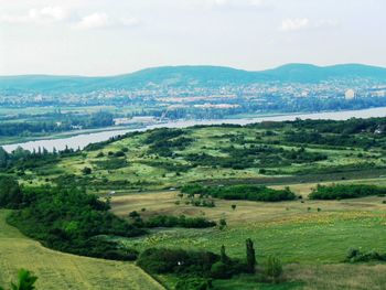 Scenic view of landscape and sea against sky