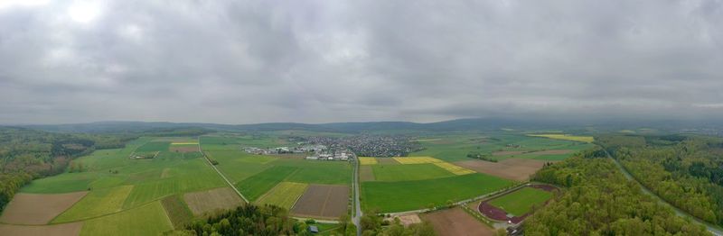 Panoramic view of agricultural field against sky