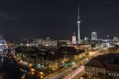 High angle view of city lit up at night