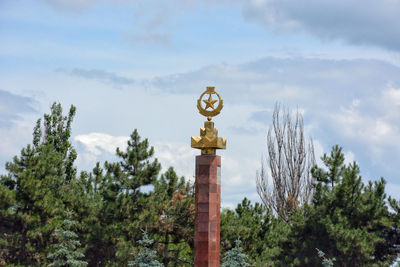 Low angle view of statue against cloudy sky