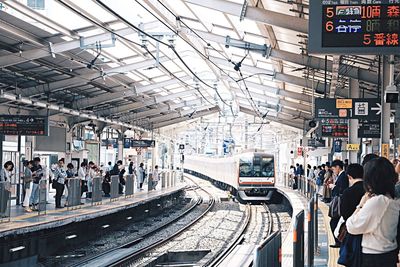 People waiting at railroad station in city