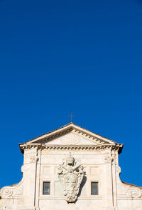 Low angle view of statue against clear blue sky