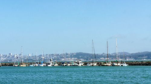 Boats moored at harbor