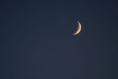 Low angle view of moon against clear sky at night