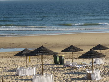 Chairs on beach by sea