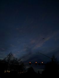 Low angle view of silhouette trees against sky at night