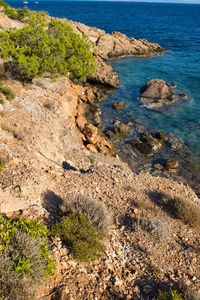 High angle view of rocks on beach against sky