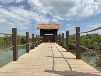 Footpath by railing against sky