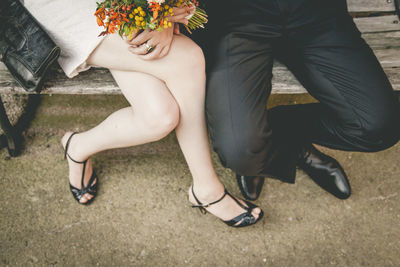 Low section of couple sitting on floor