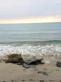 Scenic view of beach against sky during sunset