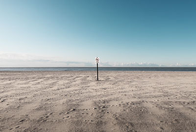 Scenic view of beach against clear blue sky