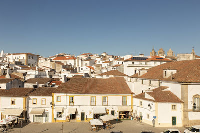 Buildings in town against clear blue sky. evora, medival city,  portugal