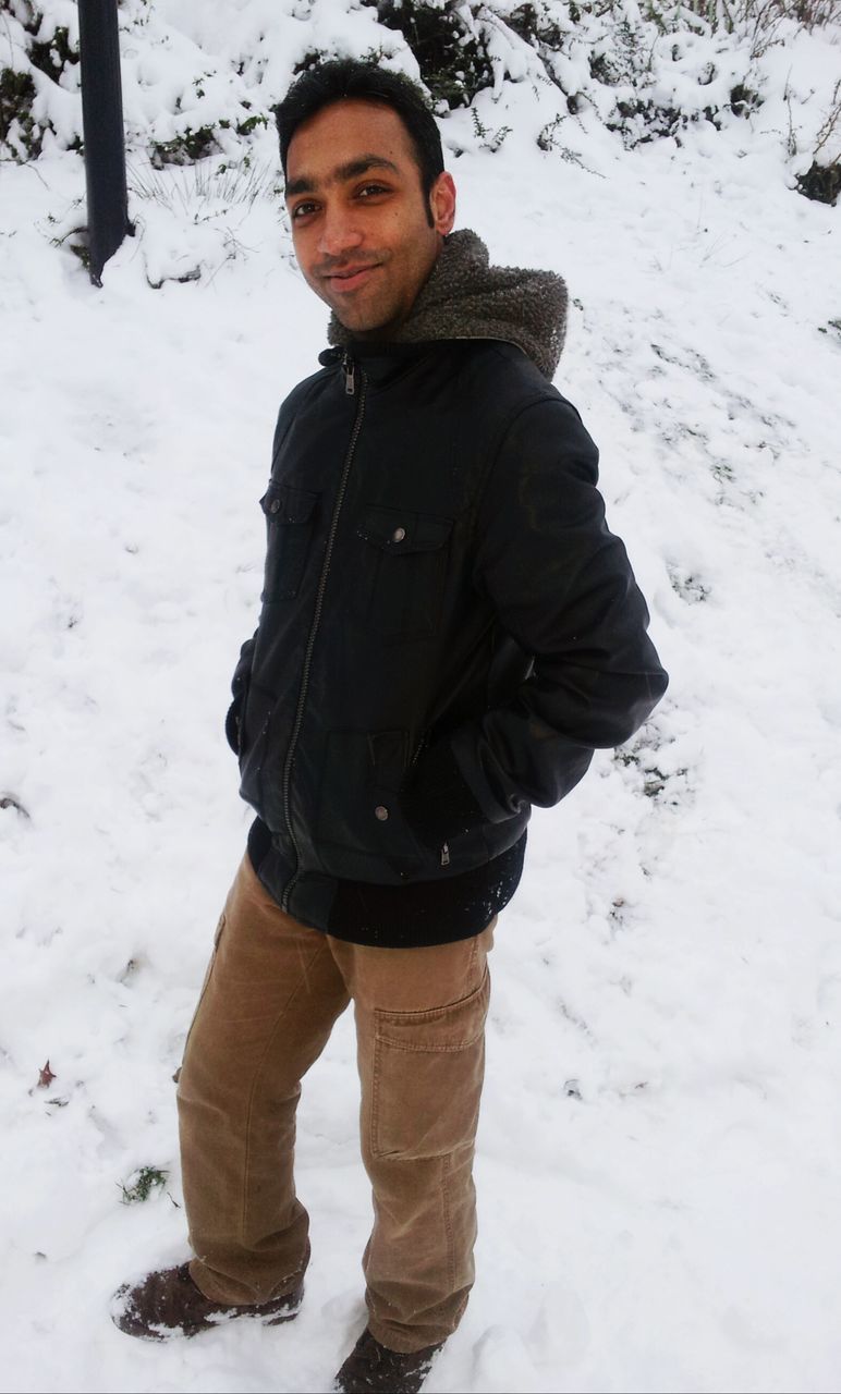snow, winter, cold temperature, lifestyles, season, person, leisure activity, portrait, looking at camera, standing, full length, front view, casual clothing, warm clothing, young adult, young men, weather, covering