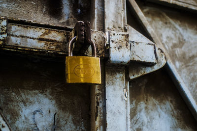 Close-up of padlocks hanging on rusty metal