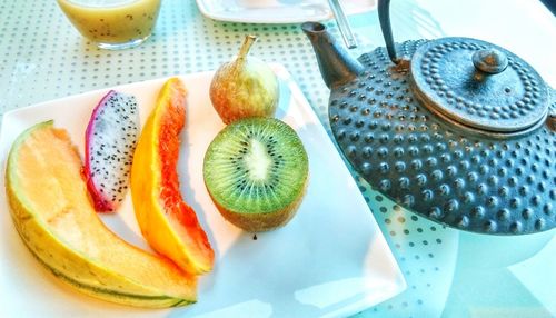 Slices of tropical fruit on plate