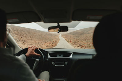 Rear view of man driving car