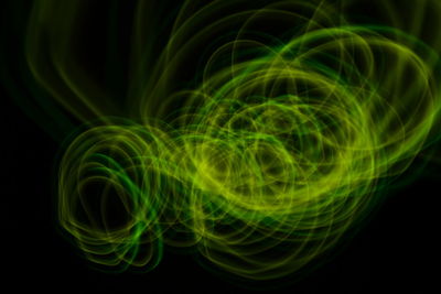 Close-up of light painting against black background