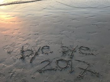 High angle view of text on beach