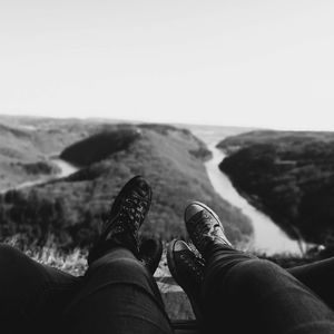 Low section of people on mountain against sky