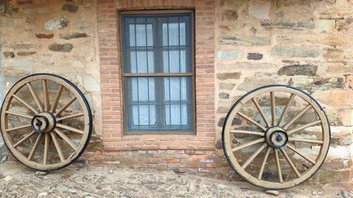 Window, wheels and stone wall